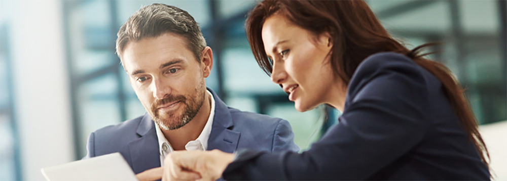 Photo of a man and a woman looking at a computer