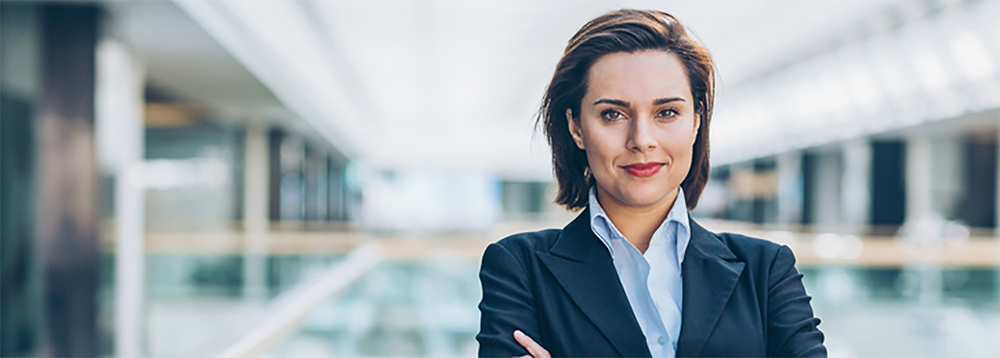 Photo of a woman arms croos in an large office